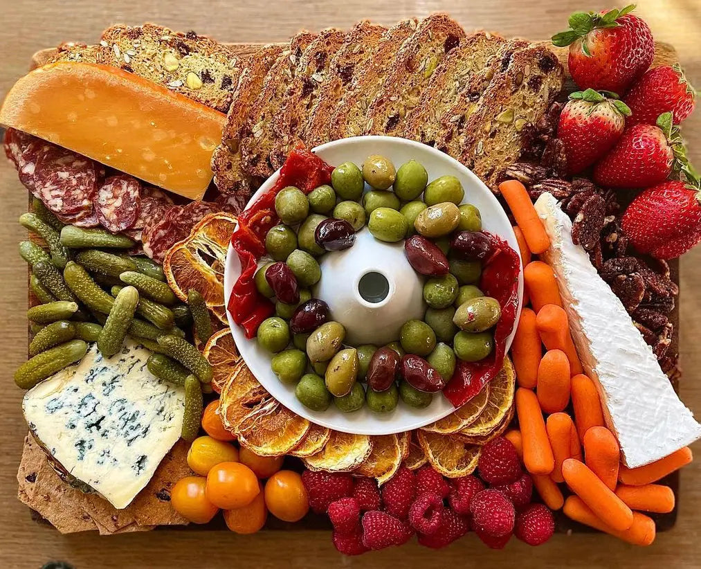 The Olive Boat as the centerpiece of a charcuterie board